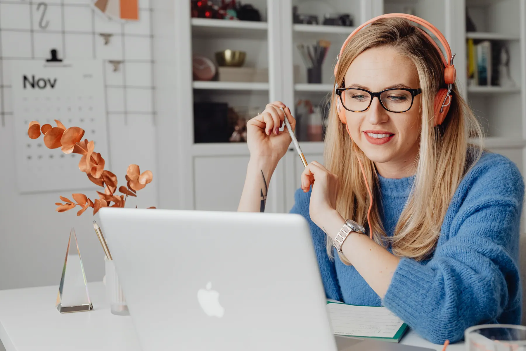 Person using headphones with a laptop at home